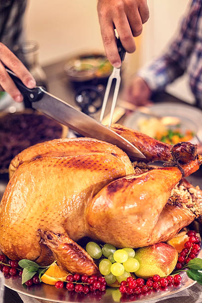 istock Carving Traditional Stuffed Turkey for Dinner 617389912