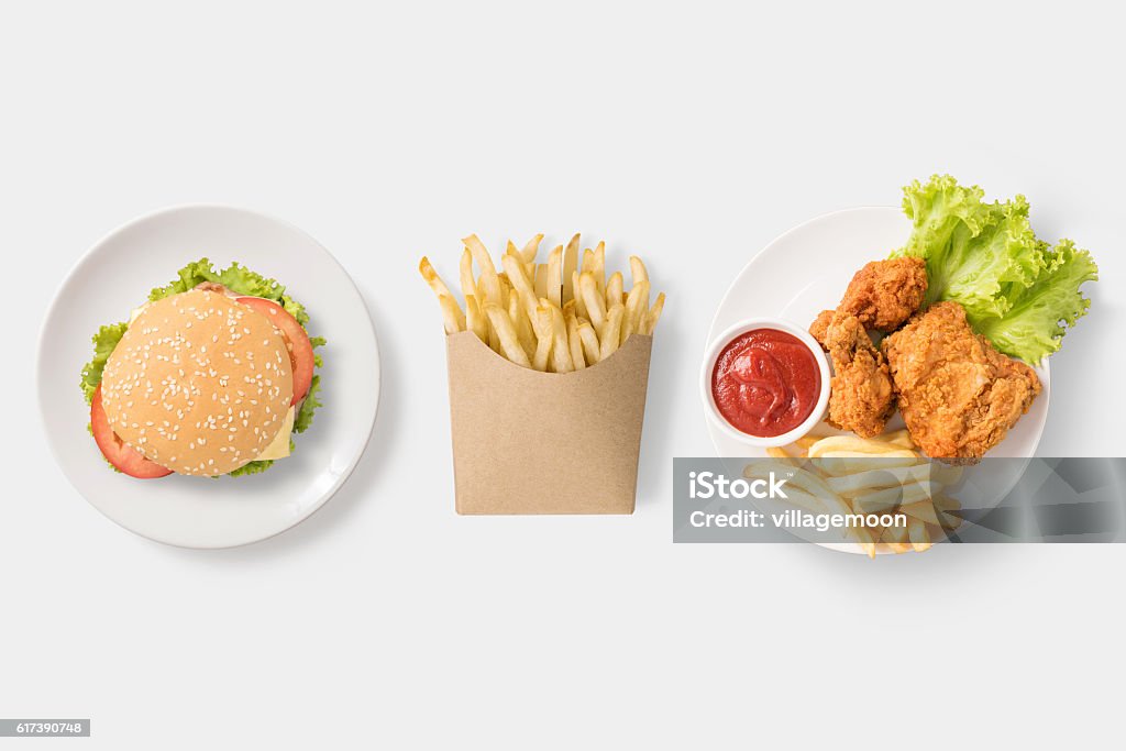 Concept of mock up burger, french fries and fried chicken. Concept of mock up burger, french fries and fried chicken set isolated on white background. Copy space for text and logo. Clipping Path included on white background. High Angle View Stock Photo