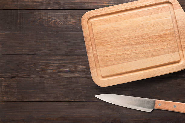 istock Knife and cutting board on the wooden background. 617391856