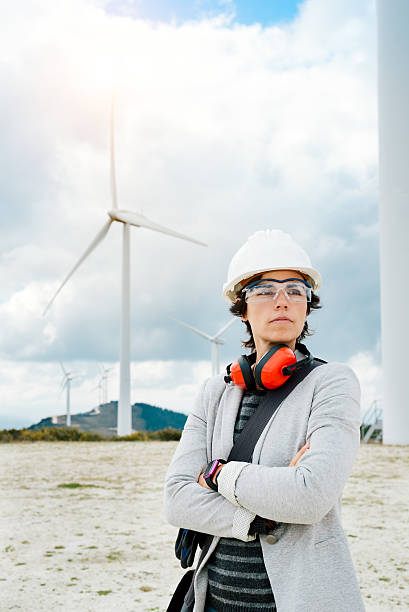 Professional female engineer after technical maintenance at  wind power plant