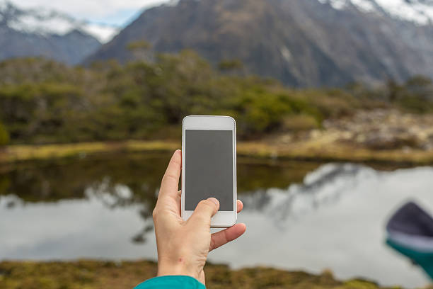 istock Close up on human hands using mobile phone in nature 617393062