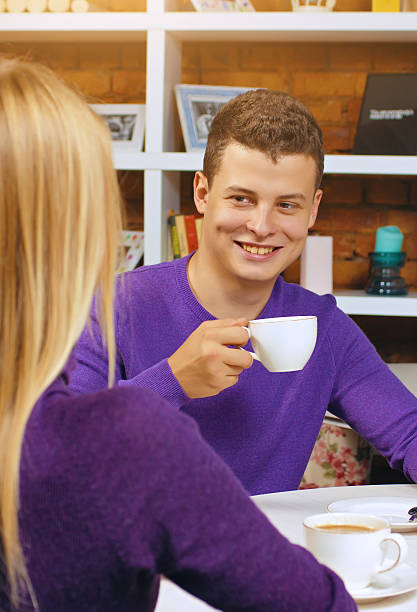 istock Young man drinking coffee and talking with a woman. Nice 617393832