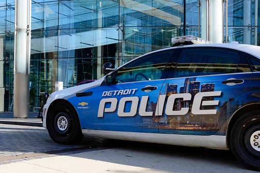 Detroit, Michigan, USA - October 23, 2016: A Detroit Police car parked in front of the Renaissance Center, world headquarters for GM in downtown Detroit.