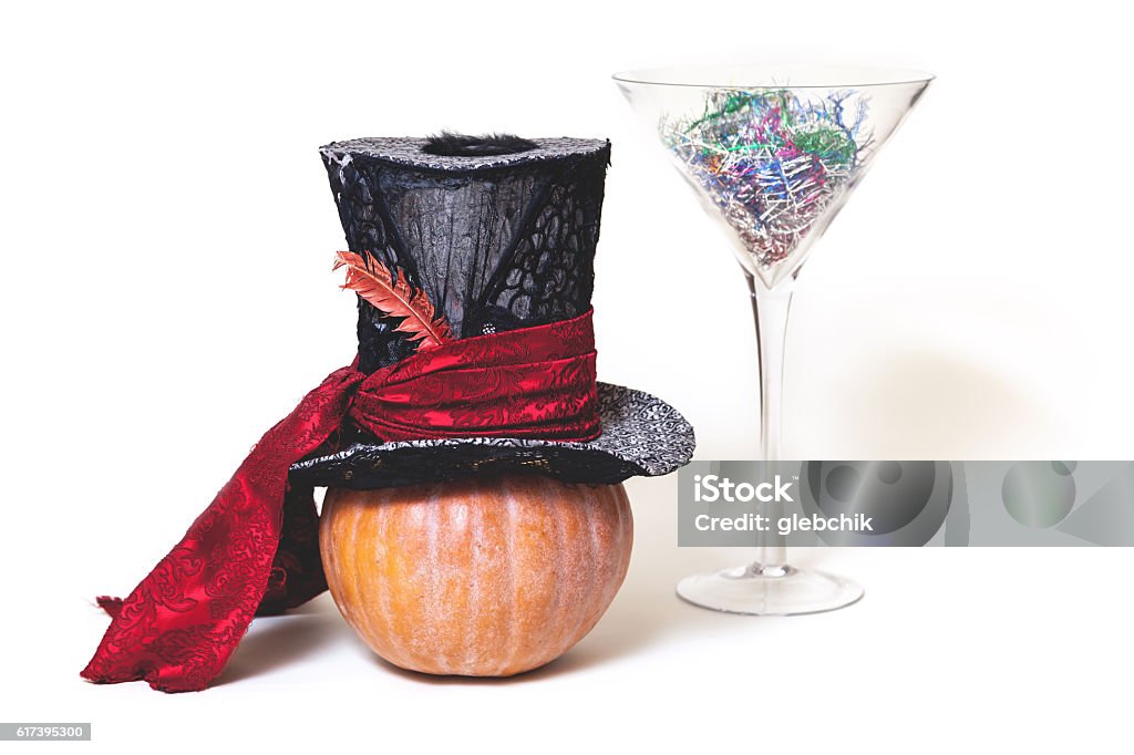 Still Fabulous. Hat, pumpkin and huge glass on white background Magic still life. Big hat cylinder ripe pumpkin and huge glass martini glass on a white background Arts Culture and Entertainment Stock Photo