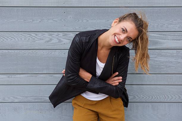 istock Smiling confident woman leaning with arms crossed 617395780