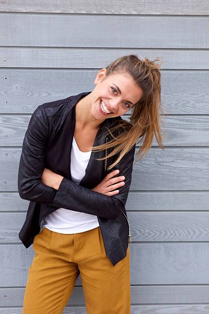 istock Laughing woman leaning with arms crossed 617395828