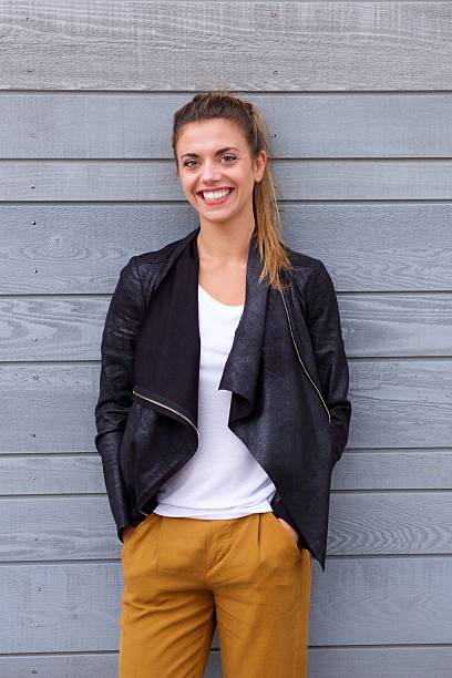 istock Beautiful smiling woman in ponytail wearing leather jacket 617395904