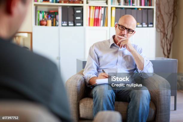 Therapy Session Adult Man Talking To His Psychotherapist Stock Photo - Download Image Now