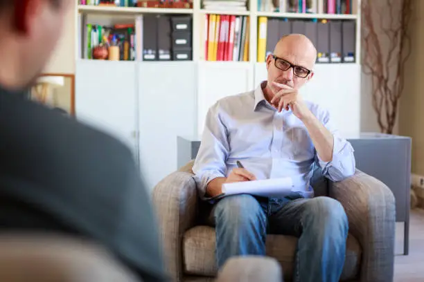 Therapy session, adult man talking to his psychotherapist