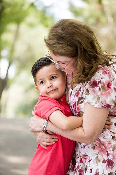 istock Grandmother embracing latin boy 617397854