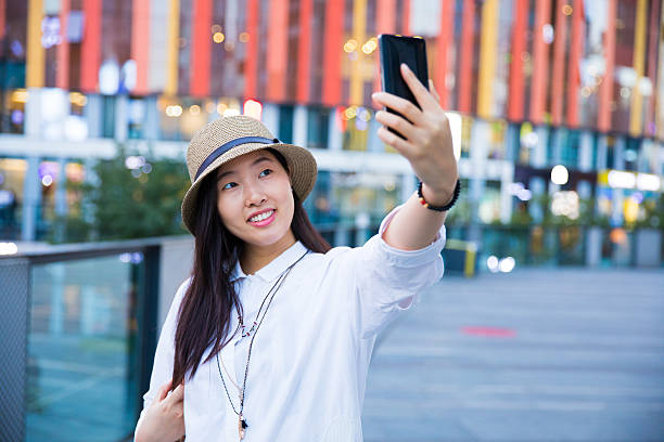 istock Young woman taking selfie 617398150