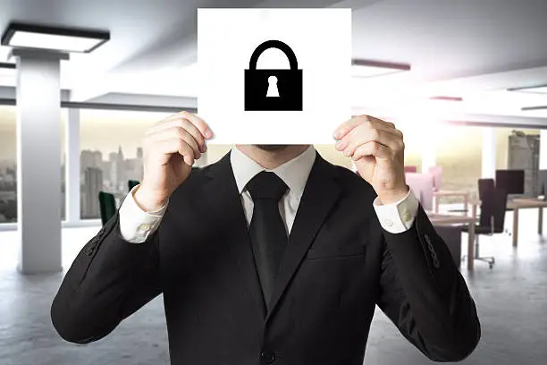 Photo of businessman in office hiding face sign lock symbol