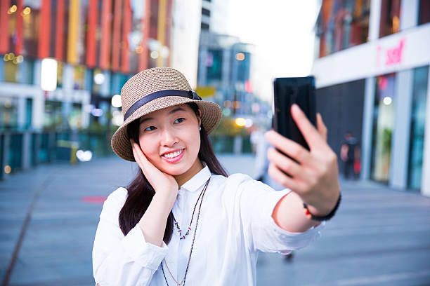 istock Young woman taking selfie 617398810