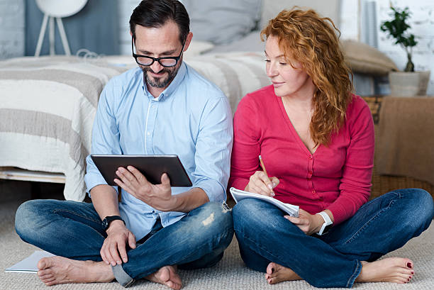 istock Middle-aged couple using tablet at home 617399044