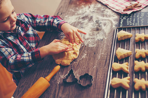 istock Child prepares homemade biscuits 617562828