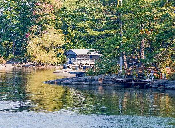 istock Sunlit Cottage on a River's bay 617562896