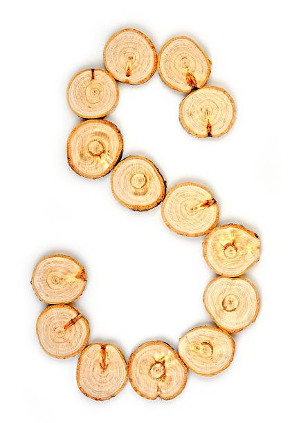 istock Alphabet letters made from Wood slice on white Background.s 617565288