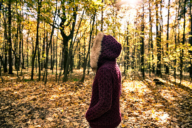 istock Woman in autumn park 617567358