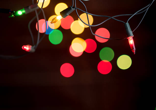istock Christmas lights over on dark background 617568328