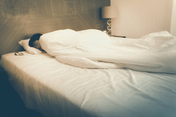 Blurry sleeping young man, closed eyes, black hair with blurred lights in corner. Vintage tone.