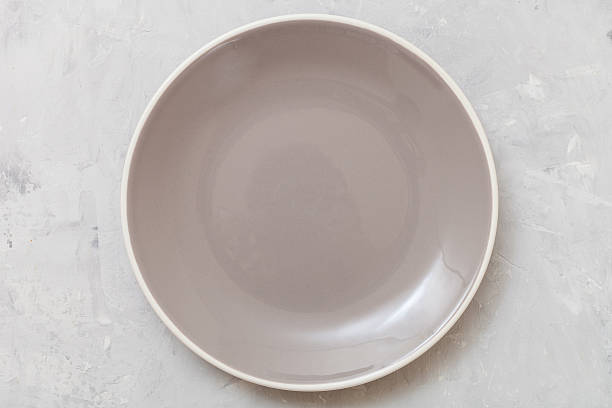 istock above view of gray plate on gray concrete surface 617568794