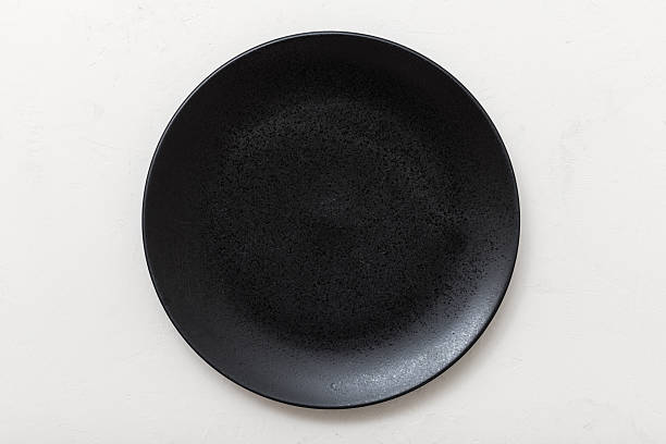 istock above view black plate on white plastering board 617569076