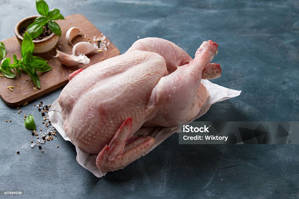 Fresh chicken with spices Fresh chicken with spices on vintage background with copyspace, selective focus. Healthy food, diet or cooking concept Chicken - Bird Stock Photo