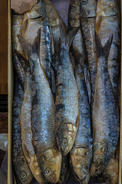 istock Box smoked sardines in a market 617569652