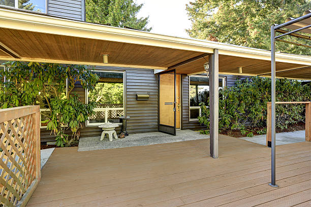istock Open entrance door and empty wooden walkout deck 617572752