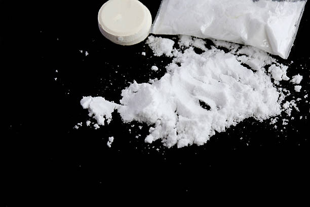 istock Narcotic drugs on a black surface. Closeup 617574872