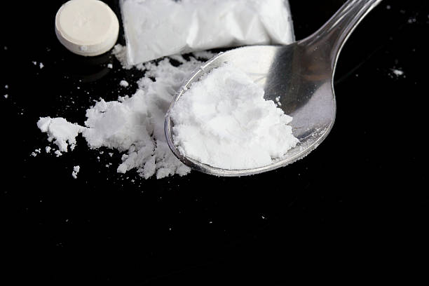istock Narcotic drugs on a black surface. Closeup 617574994