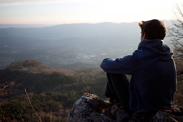 istock Young adult looking at a view 617575200