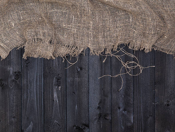 istock Burlap on old wooden table background, top view 617575732