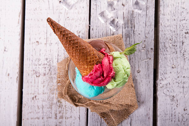 istock Ice cream in cup with cone on a wooden table 617576034