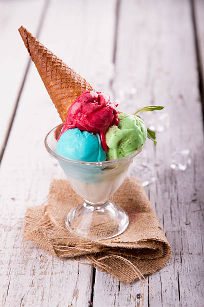 istock Ice cream in cup with cone on a wooden table 617576192