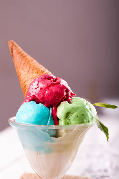 istock Ice cream in cup with cone on a wooden table 617576300