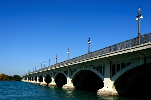 The Belle Isle Bridge, also known as the MacArthur Bridge, completed in 1923, and connects the island to Detroit.