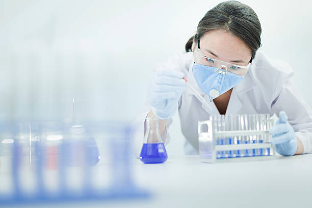 Asian woman scientist working with chemical in a laboratory. stock photo