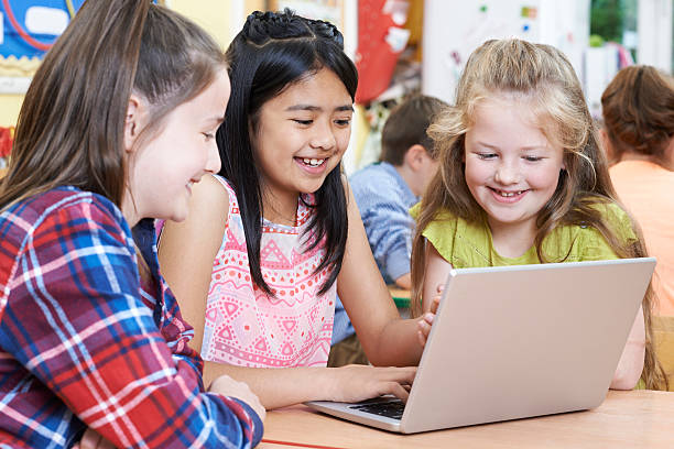 istock Group Of Elementary School Children Working Together In Computer 617578092