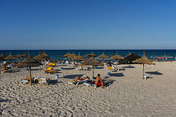 Beach in Sousse, Tunisia Sousse, Tunisia - August 17, 2011: Tourists sunbathing at the beach at Sousse, resort town in Tunisia. In 2015, terrorist attack happened at the beach of Sousse. sousse tunisia stock pictures, royalty-free photos & images