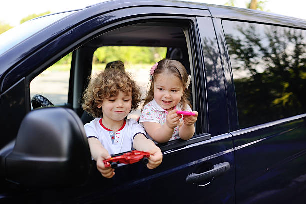 istock children look out from a car window 617580684