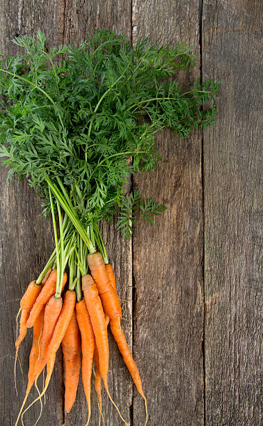 istock fresh carrots on wooden surface 617581414