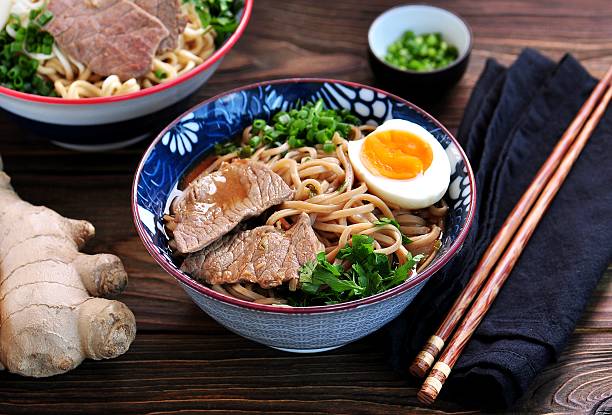 istock Soup with soba and ramen noodles, beef, ginger, green onions 617581592