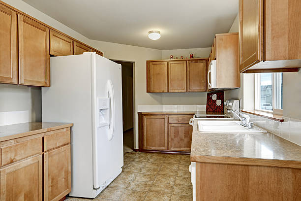 istock Wooden kitchen storage combination and white fridge 617582652