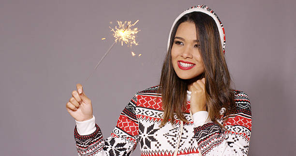 istock Pretty woman celebrating Christmas with fireworks 617584536