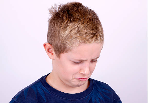 istock Portrait of Confused Boy 617585440