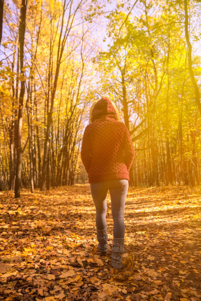 istock Woman in autumn park 617585650