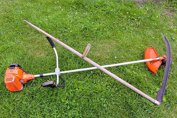 istock Spit and petrol trimmer for mowing grass 617585984