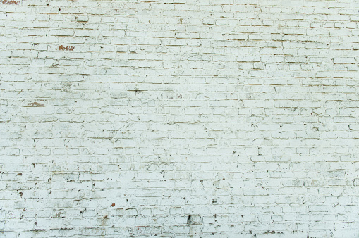 Old weathered white brick wall. Vintage texture Background.