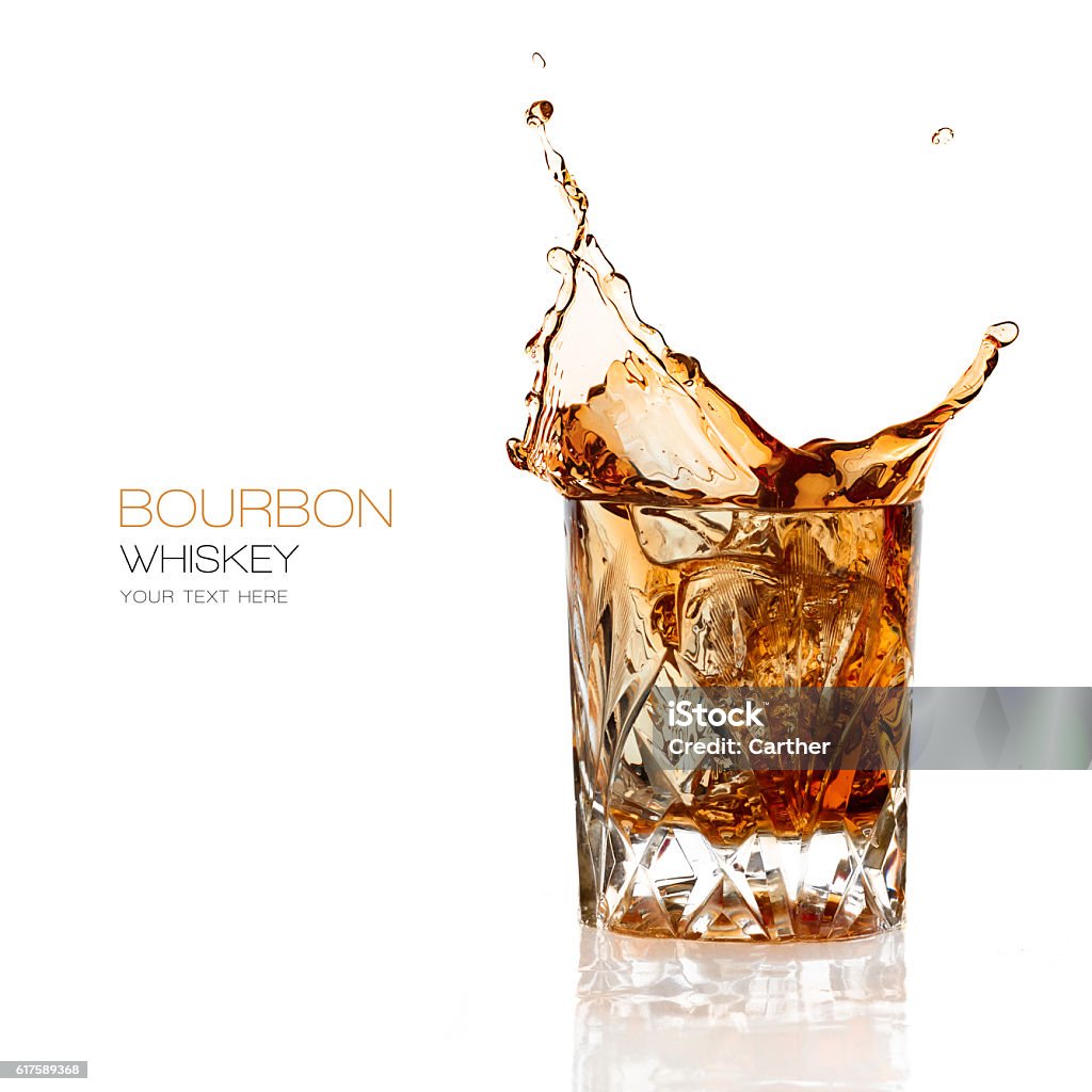 Bourbon Whiskey Splash Isolated on White Background Bourbon whiskey splash in an elegant glass cut glass isolated on white background with copy space for text Whiskey Stock Photo